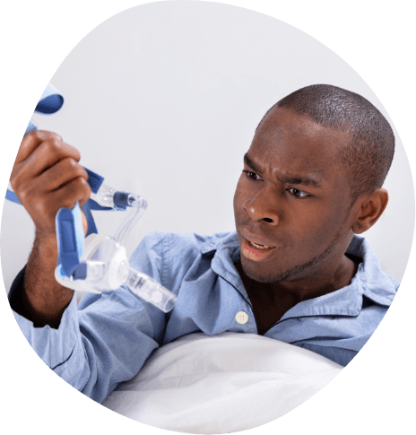 Confused man looking at C P A P machine