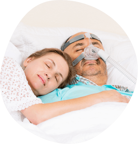 Man with C P A P cuddling with woman while sleeping