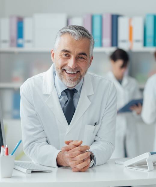 Smiling doctor sitting at desk