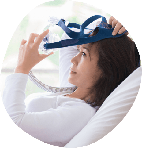 Woman placing a C P A P mask over her face
