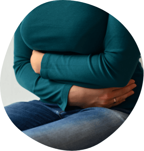 Person hugging their own torso while sitting