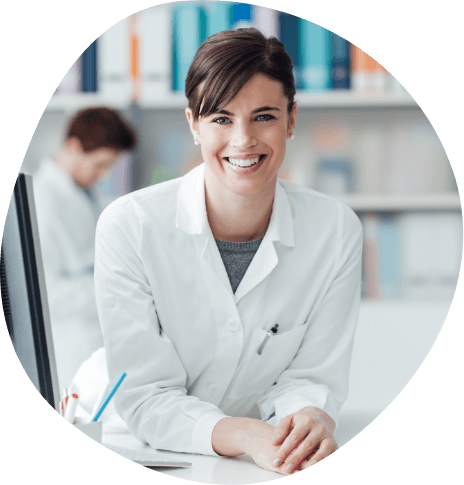 Smiling person in white lab coat