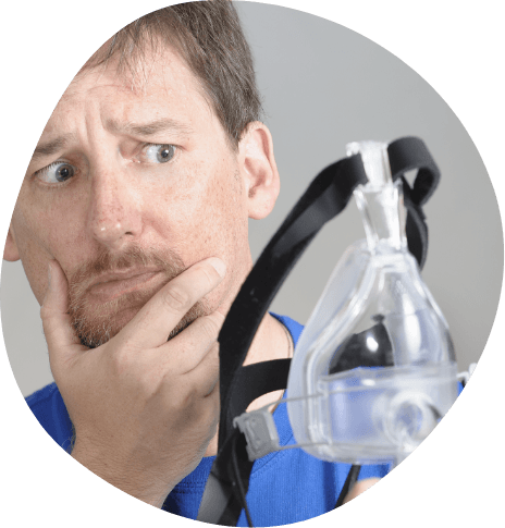 Man looking hesitantly at C P A P mask