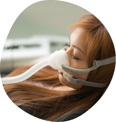 Woman sleeping while wearing C P A P mask