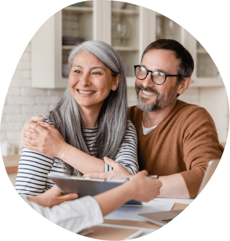 Man and woman talking to sleep center team member at table