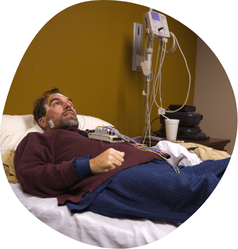 Man hooked up to electrodes for a sleep apnea test