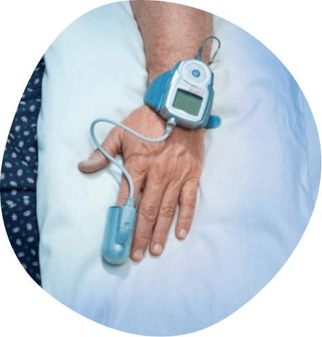 Person wearing medical finger sensor on their index finger