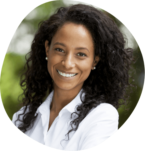 Woman in white collared shirt smiling outdoors