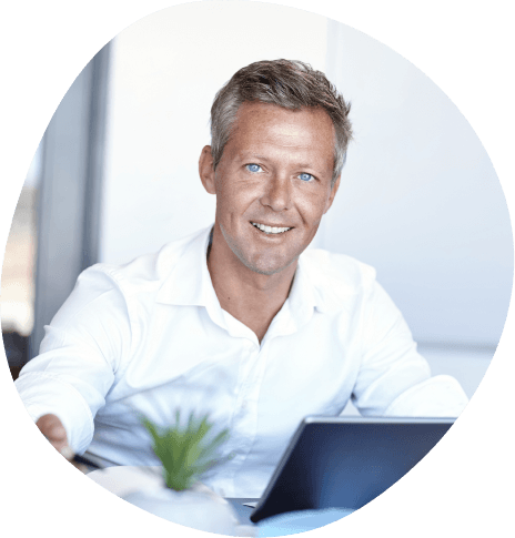 Smiling businessman sitting at desk