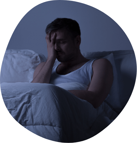 Frustrated man lying awake in bed