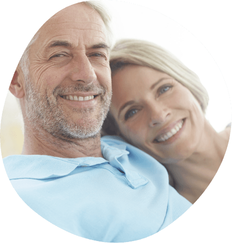 Man and woman grinning together outdoors