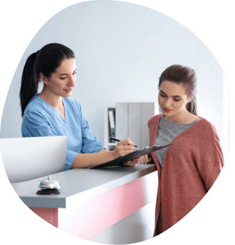 Sleep center team member showing a clipboard to a patient
